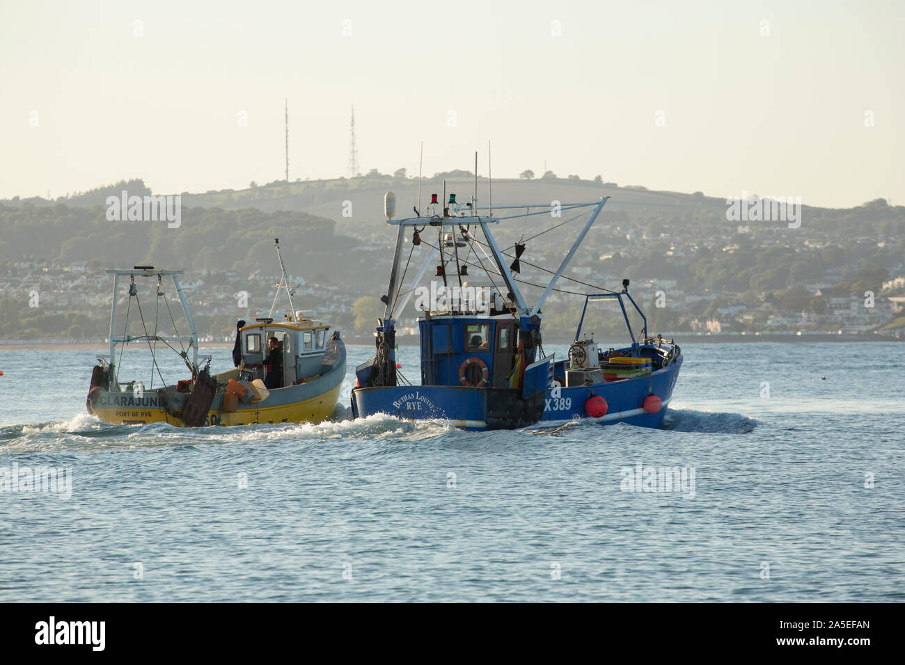 Deux bateaux de pêche aller Brixham Harbour. Brixham est le foyer d'un grand nombre de bateaux de pêche et un marché aux poissons. Devon, Angleterre Royaume-uni GB Banque D'Images