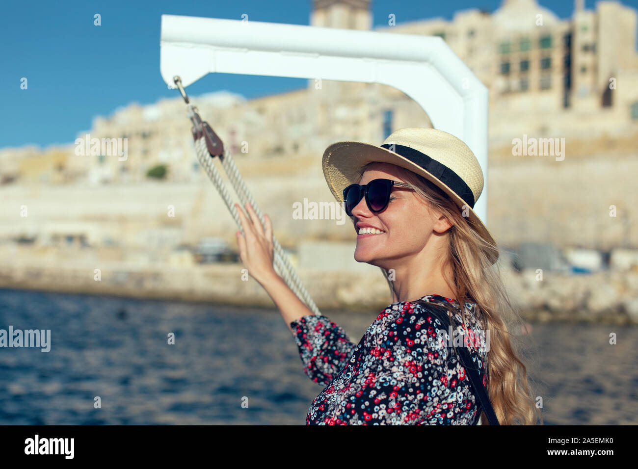 Jeune blonde excité 20s femme arrivant à destination méditerranéenne sur mer Banque D'Images