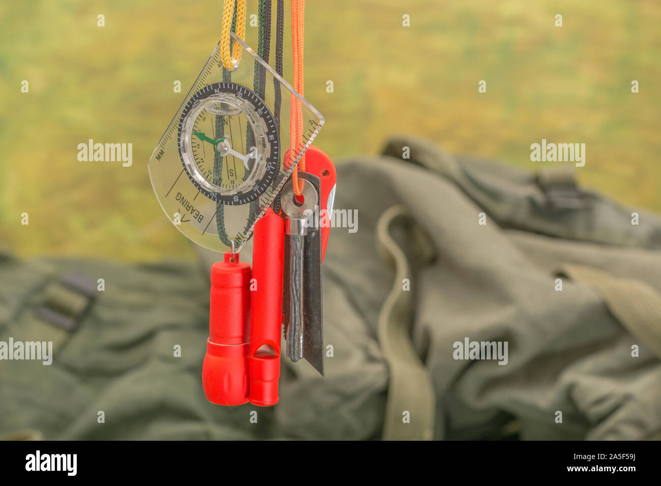 Compétences et équipement de survie. Chasseur de survie à haute visibilité, sifflet de survie, torche de survie à haute viz, couteau à haute viz, boussole de survie, trousse d'urgence. Banque D'Images