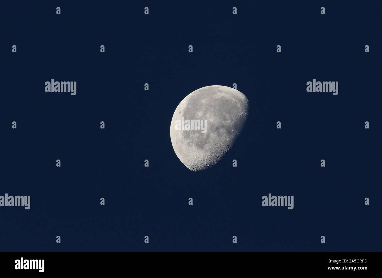 Une phase de la lune against a blue sky au Royaume-Uni. Banque D'Images