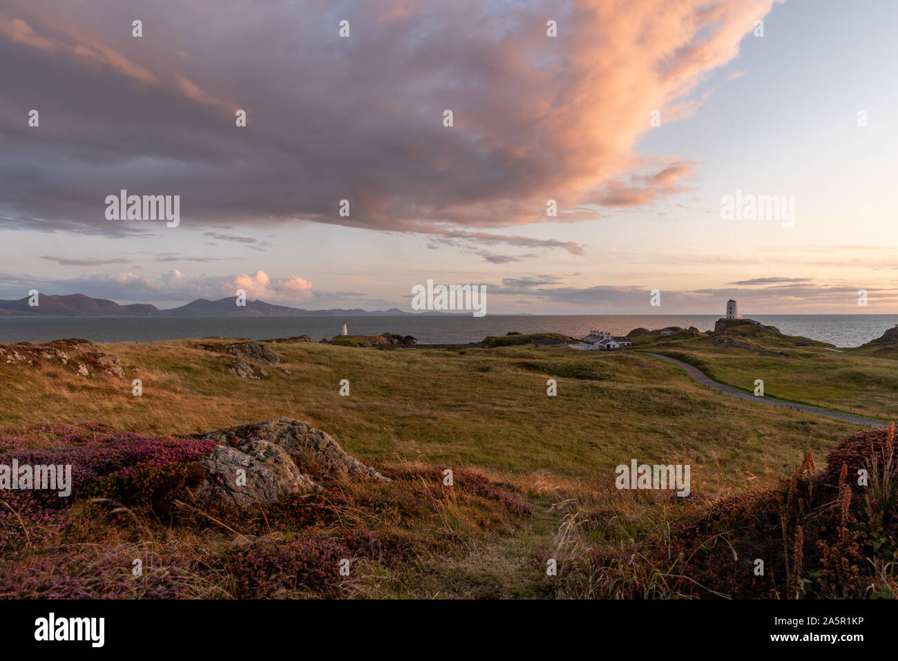 Le phare de l'île Llanddwyn, Twr Mawr à Ynys Llanddwyn sur Anglesey, au nord du Pays de Galles au coucher du soleil. Banque D'Images