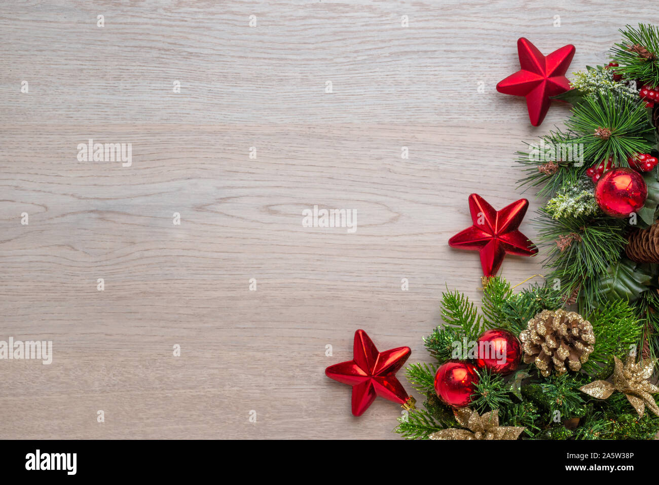 Fond de Noël avec des décorations sur woode surface. L'espace de copie, mise à plat, vue supérieure de la composition. Rouge brillant boules, étoiles et des pommes de pin sur le sapin. Banque D'Images