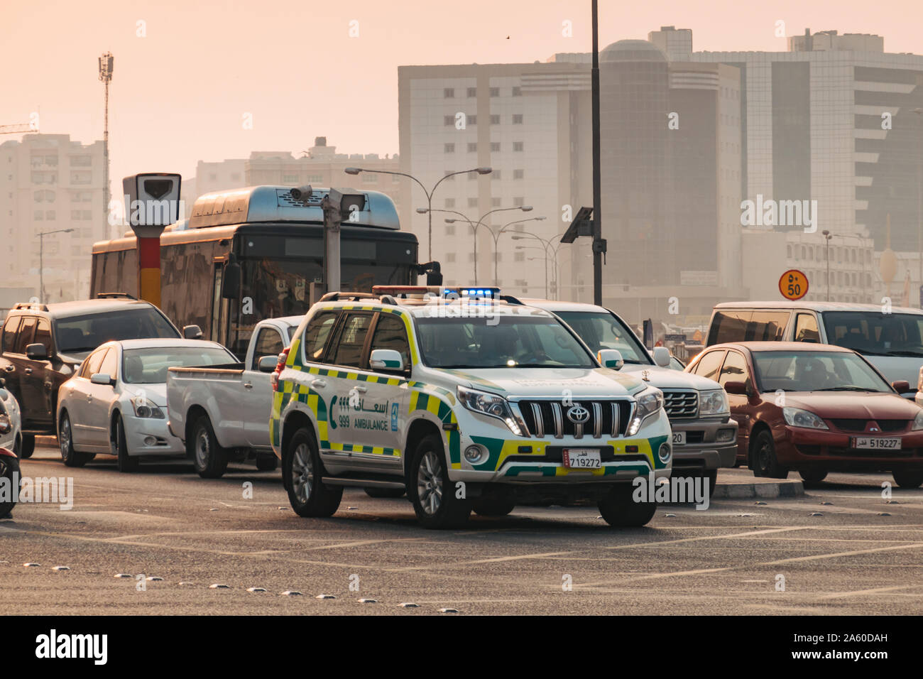 Un ambulancier dans une ambulance Toyota SUV Prada utilise la coupe sirène le trafic à une intersection, en route d'une urgence, à Doha, Qatar Banque D'Images Un ambulancier dans une ambulance Toyota SUV Prada utilise la coupe sirène le trafic à une intersection, en route d'une urgence, à Doha, Qatar Banque D'Images