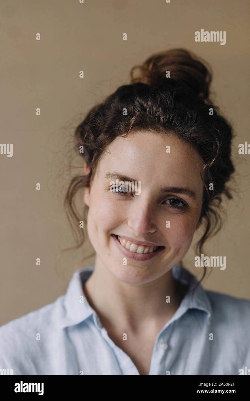 Portrait of smiling young woman with bun Banque D'Images