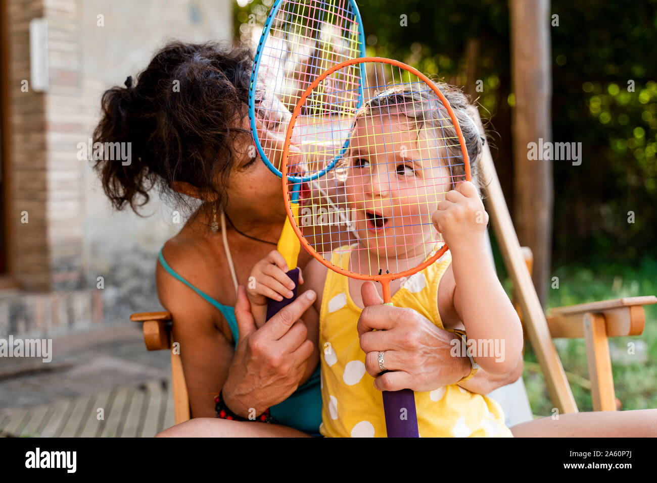 Grand-mère jouant avec petite fille et raquettes de badminton en plein air Banque D'Images