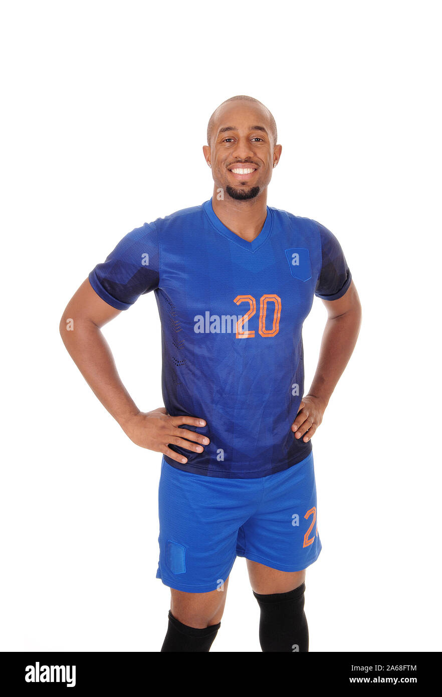 Une happy smiling African American soccer player debout dans son uniforme dans le studio, smiling, isolée pour fond blanc Banque D'Images