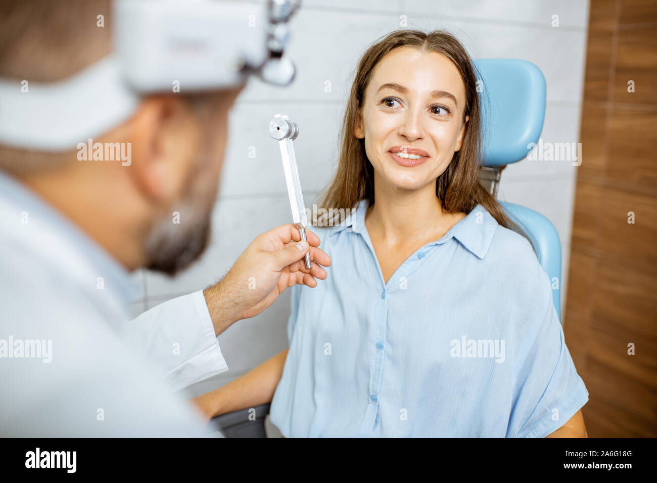 L'examen oto-rhino-laryngologiste hauts épis avec diapason ORL pour un jeune patient dans le bureau médical. Test de l'audition à lames vibrantes concept Banque D'Images