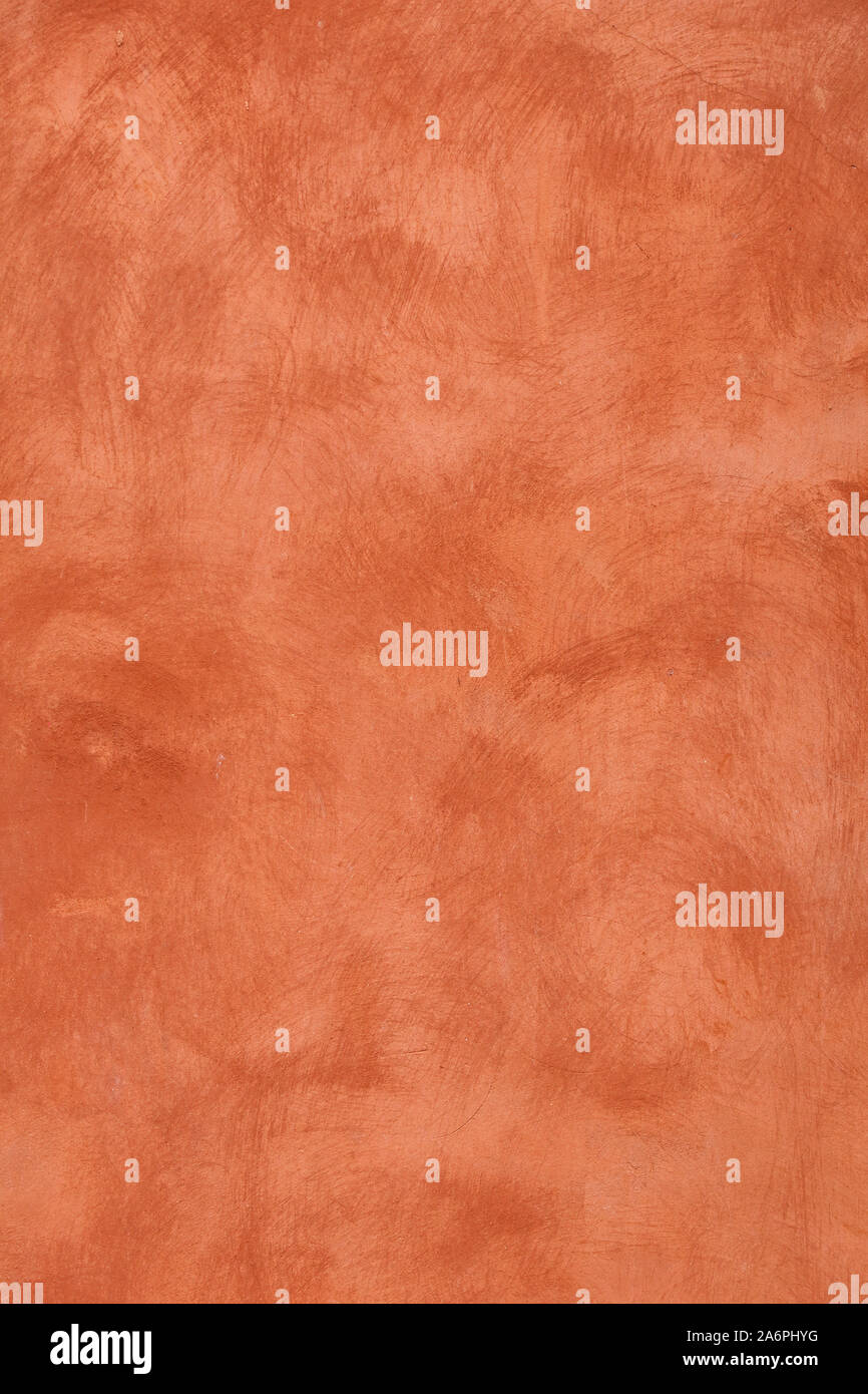 Grunge orange brun pâle vieux inégale de daub mur de plâtre texture background de taches et de traits de peinture, Close up Banque D'Images