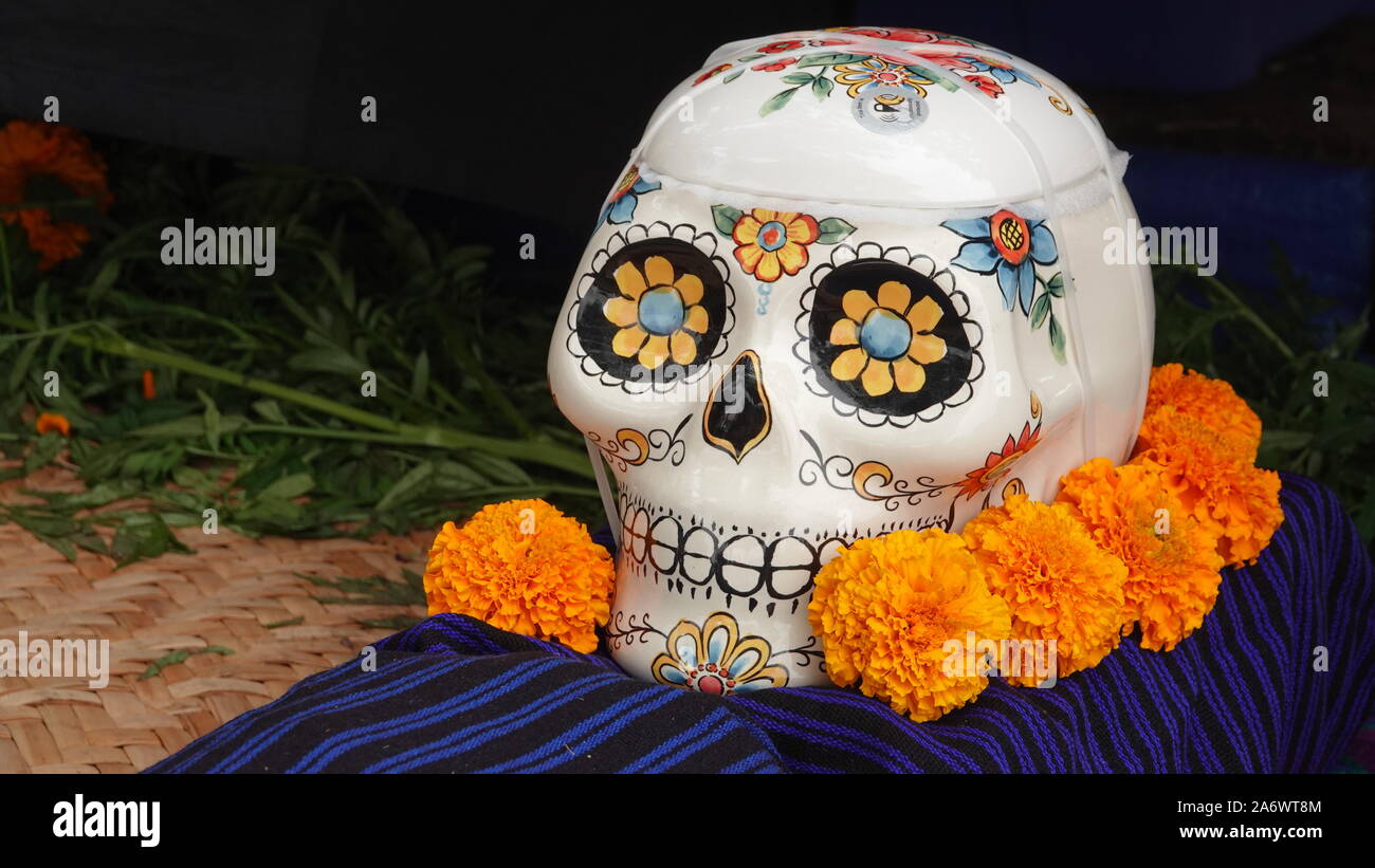 Les crânes en sucre et fleurs font partie intégrante de la Journée des morts autel affiche Banque D'Images
