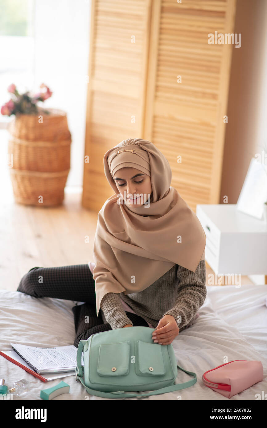 Femme élégante assise sur le mauvais à la recherche de crème main Banque D'Images