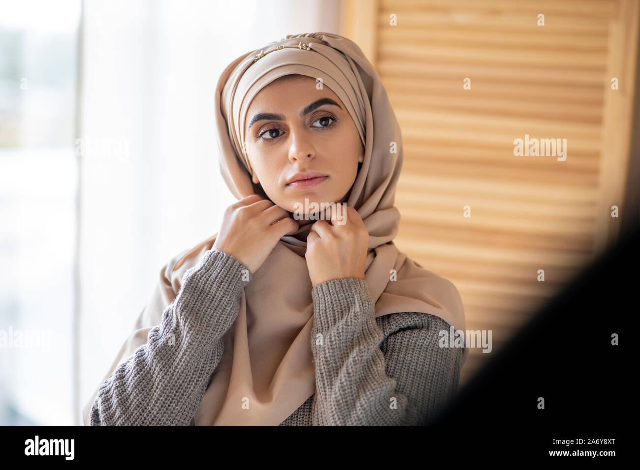 Beautiful Girl wearing hijab à la recherche dans le miroir Banque D'Images