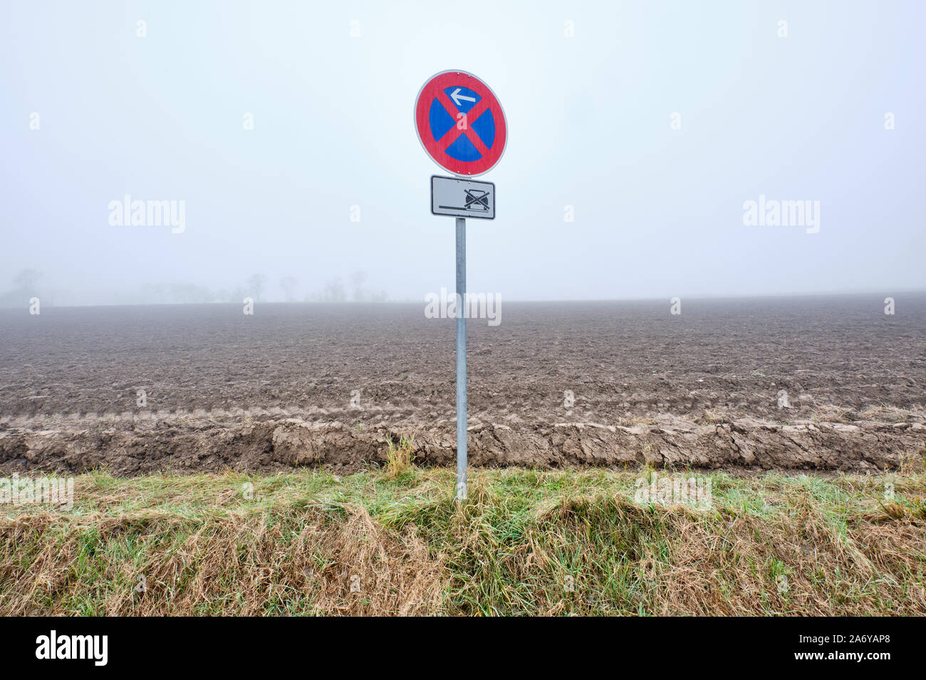 Panneau de circulation pour l'arrêt absolu de restriction d'un matin brumeux dans un paysage d'automne avec un immense domaine agricole dans l'arrière-plan. Vu en F Banque D'Images