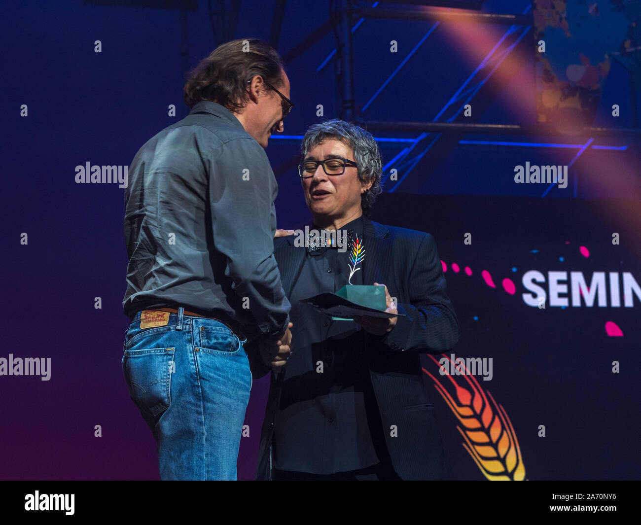 Yolanda Moreno hace entrega de la Espiga Arcoiris de la 64 Seminci un Stephen Smith, directeur général de Avalon Films por el film 'Et puis nous avons dansé". Banque D'Images