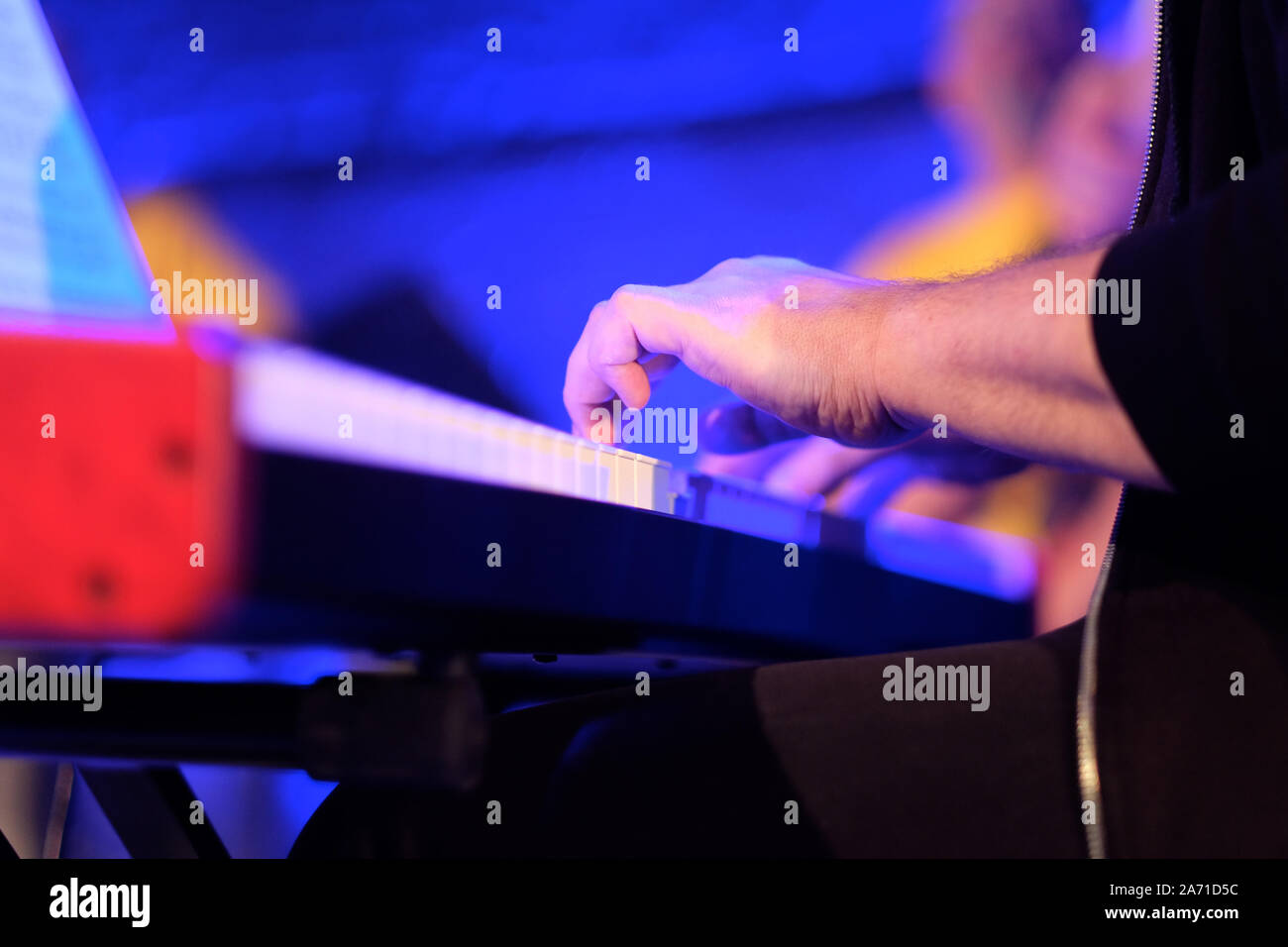 Un musicien sur un piano électrique joue la musique en direct à un concert d'un orchestre Banque D'Images