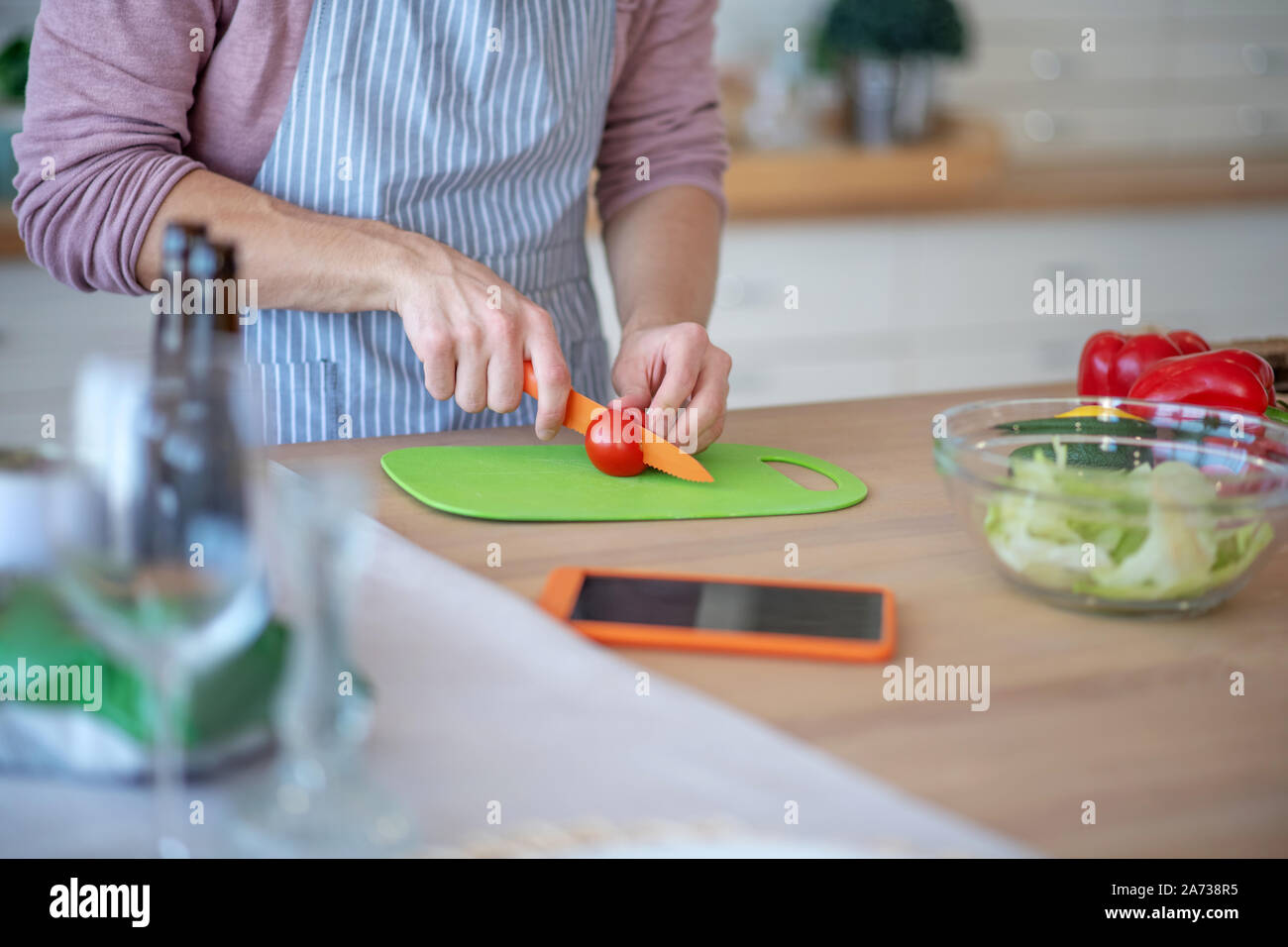 Close up of man slicing tomatoes salade pendant la cuisson Banque D'Images