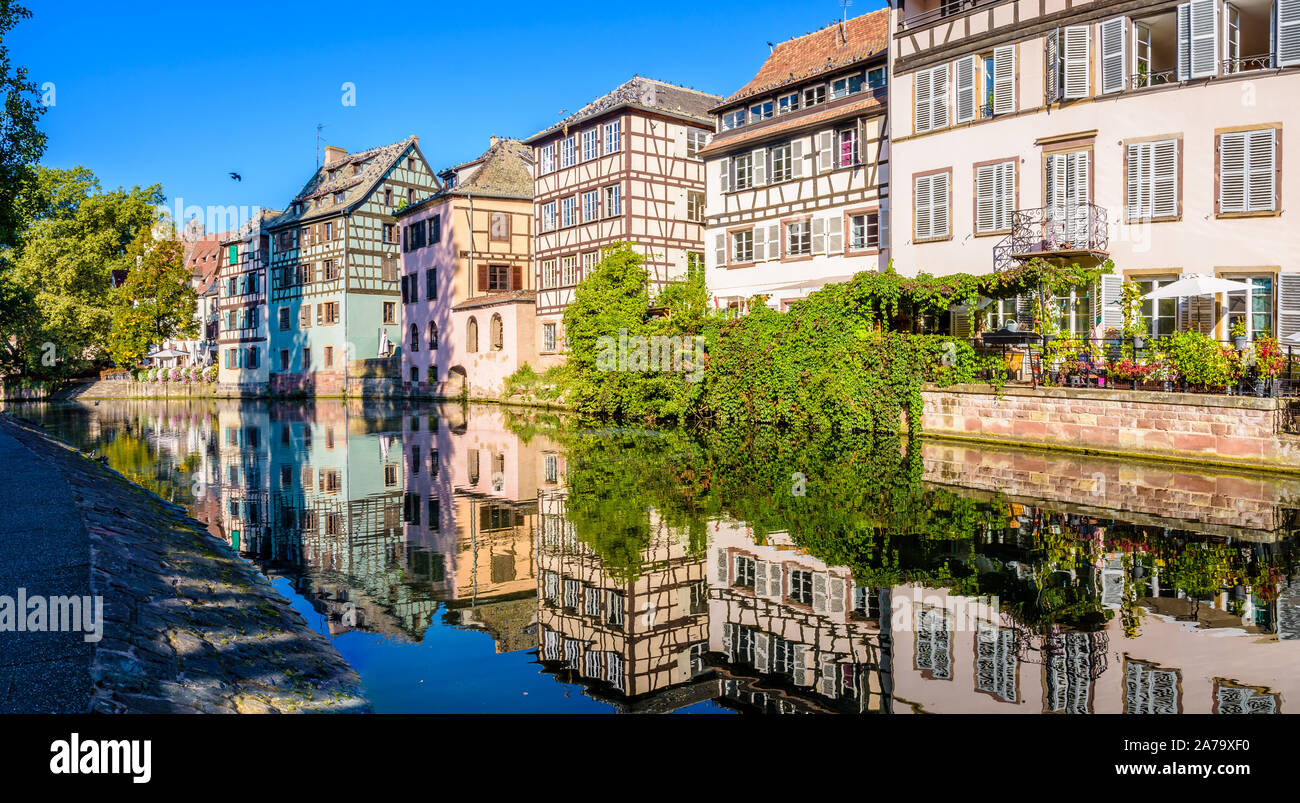 Vue panoramique sur les maisons à colombage se reflétant dans l'eau du canal de l'Ill dans le quartier de la Petite France à Strasbourg, France. Banque D'Images