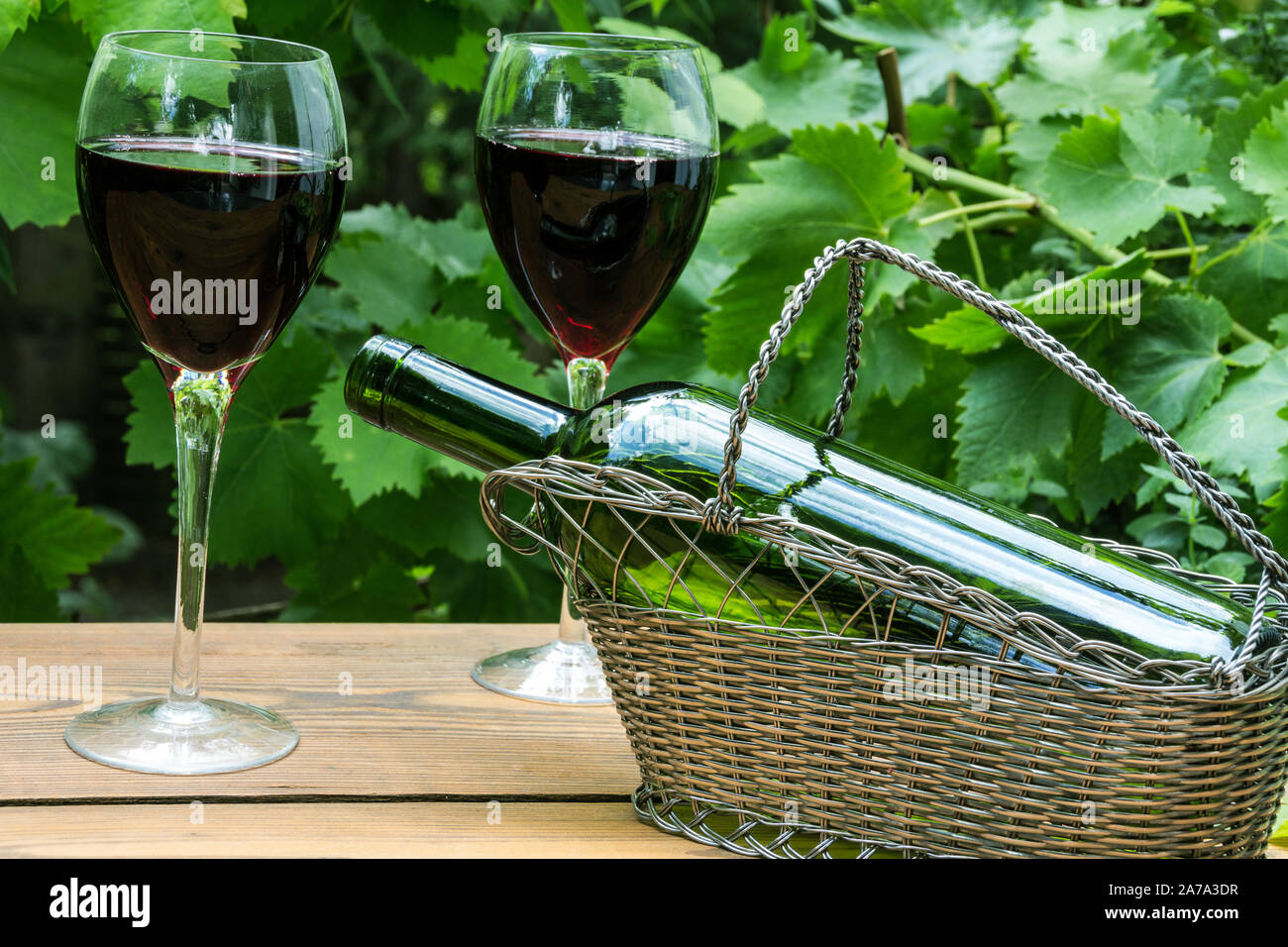 Verres à vin rouge de feuilles de vigne dans le jardin Banque D'Images