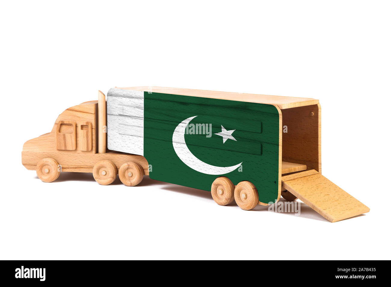 Close-up d'un camion jouet en bois peint avec un drapeau national du Pakistan. Le concept d'exportation-importation, transport, livraison de marchandises nationales Banque D'Images