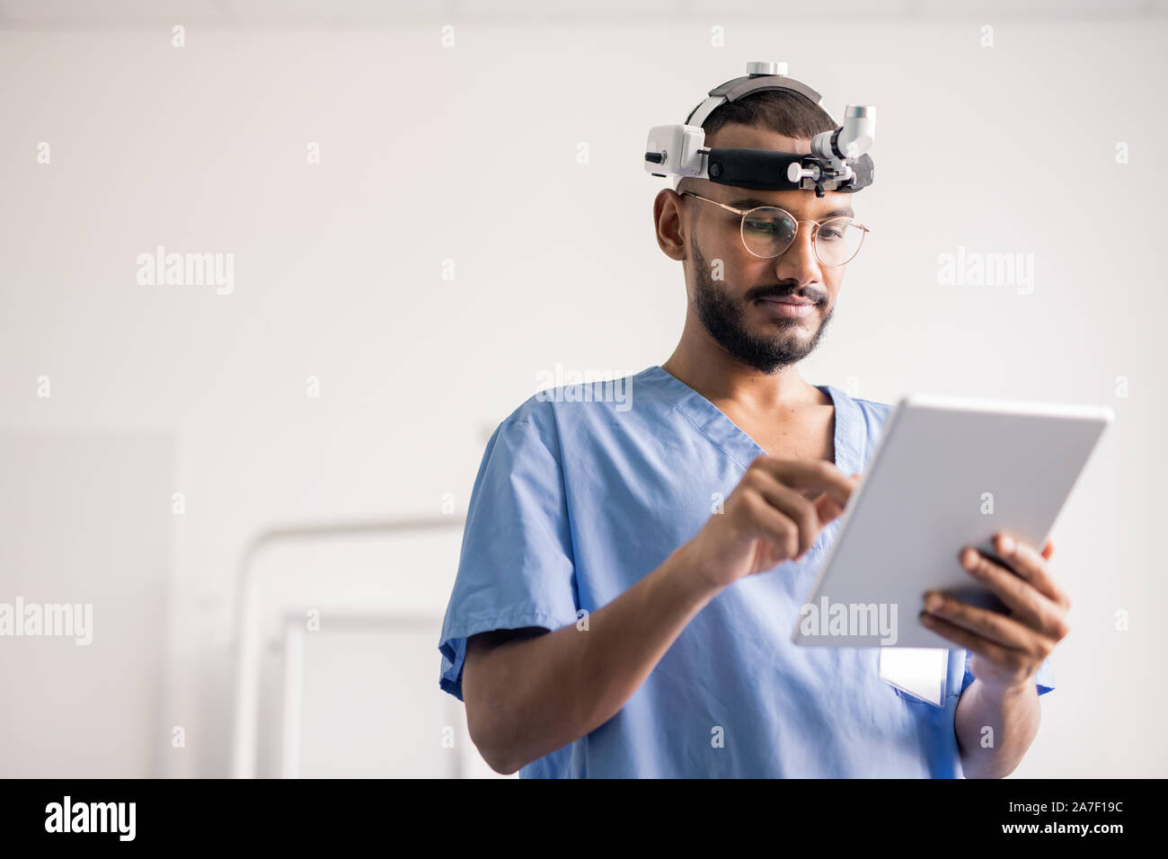 Les jeunes professionnels médicaux avec surface tactile du défilement des données en ligne au travail Banque D'Images