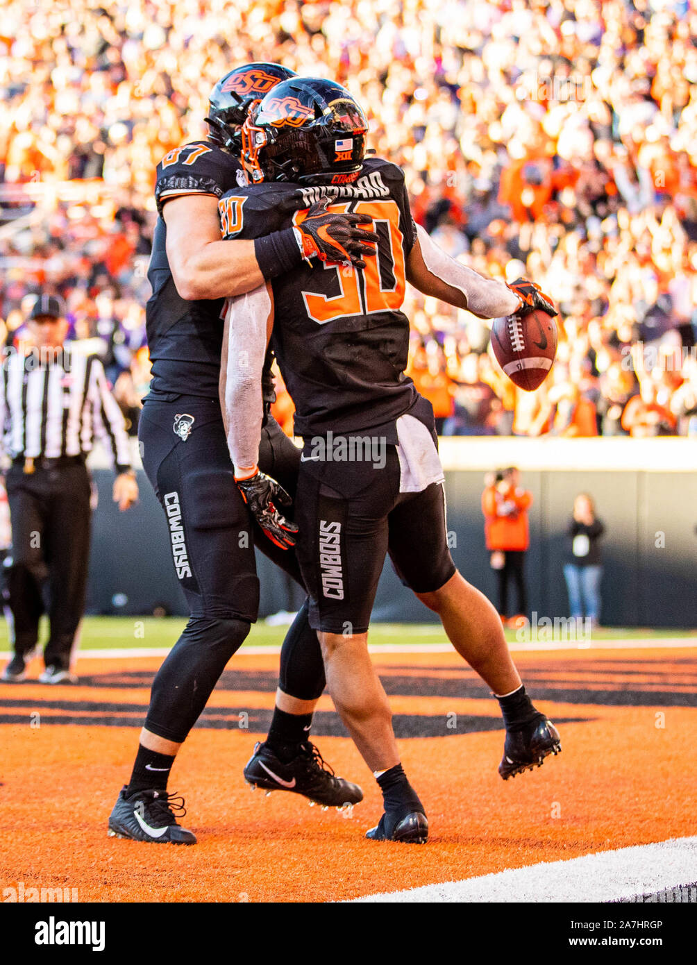 Stillwater, Oklahoma, USA. 2e Nov, 2019. Oklahoma State Cowboys running back Chuba Hubbard (30) célèbre son toucher avec la main l'extrémité Logan Carter (87) au cours de la partie le samedi, Novembre 02, 2019 à Boone Pickens Stadium à Stillwater, Oklahoma. Credit : Nicholas Rutledge/ZUMA/Alamy Fil Live News Banque D'Images