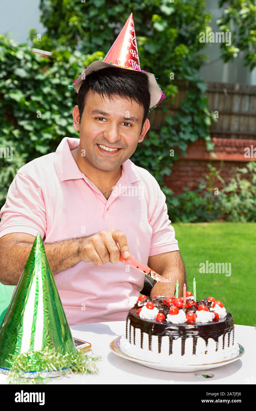 Heureux Homme Adulte De Couper Le Gateau D Anniversaire Celebration Anniversaire Seul En Jardin De La Maison Photo Stock Alamy