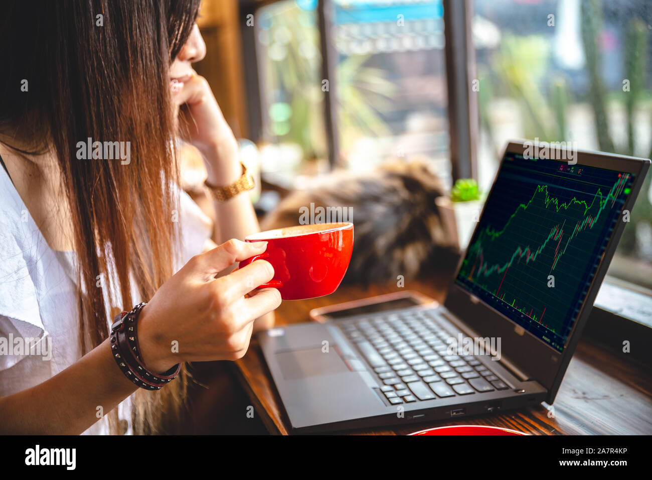 Stock Trader Intraday businesswoman working at coffee shop bar for business cafe hopper de vie. Banque D'Images