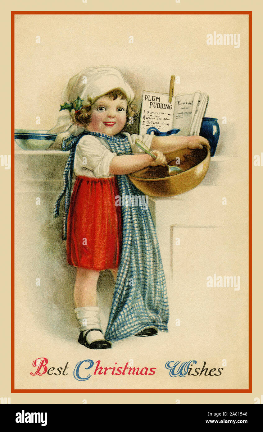 American Vintage 'MEILLEURS VOEUX DE NOËL'' carte postale cute Victorian girl doing certains accueil Noël cuisson. Un livre coincé ouvert à une recette de plum-pudding est sur le comptoir derrière la jeune fille. Le message sur la carte est : Meilleurs Voeux de Noël. (L'illustratrice Ellen Clapsaddle.) USA Banque D'Images