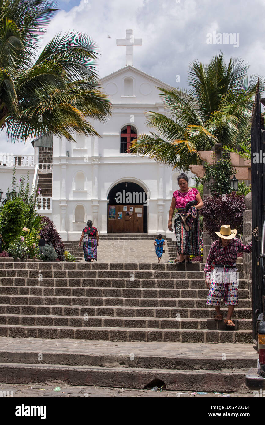 Un vieux homme Maya et une femme maya, tant en vêtements traditionnels, descendre les escaliers de la place en face de l'église de San Pedro en Banque D'Images