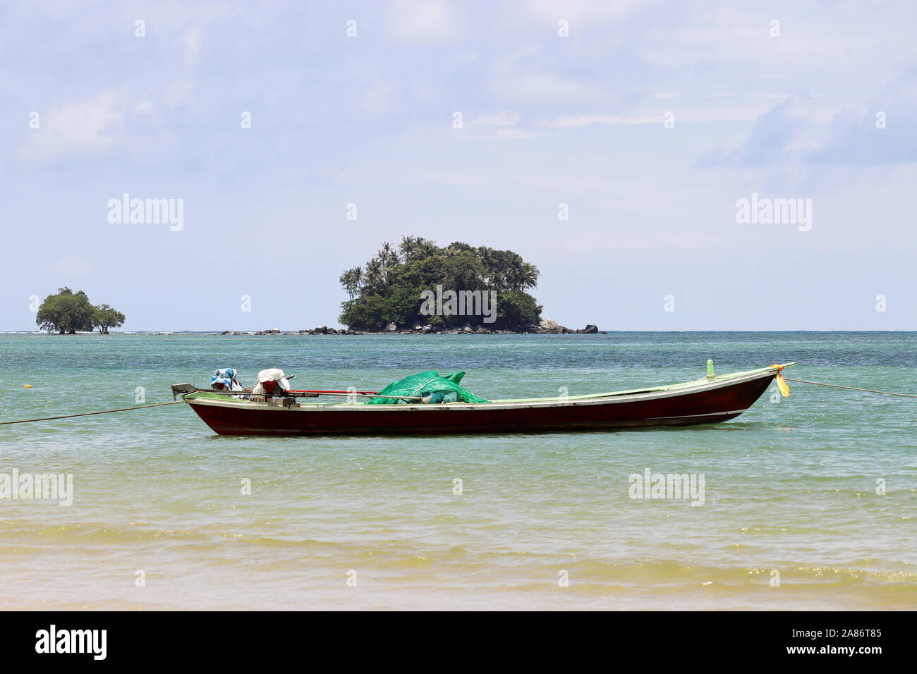 Bateau de pêche dans la mer de l'arrière-plan sur les îles tropicales avec des cocotiers. Seascape pittoresque en Thaïlande Banque D'Images