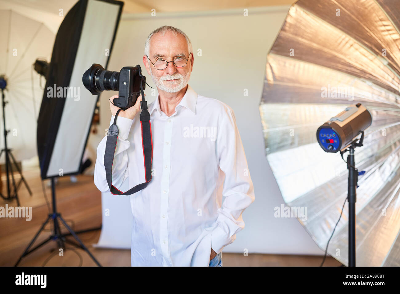 Man en tant que photographe professionnel avec caméra dans le studio photo Banque D'Images