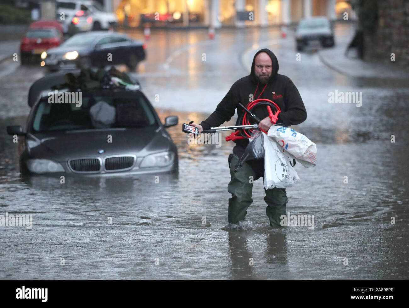 Un homme patauge dans une rue inondée Sheffield, après des pluies torrentielles dans la région. Banque D'Images