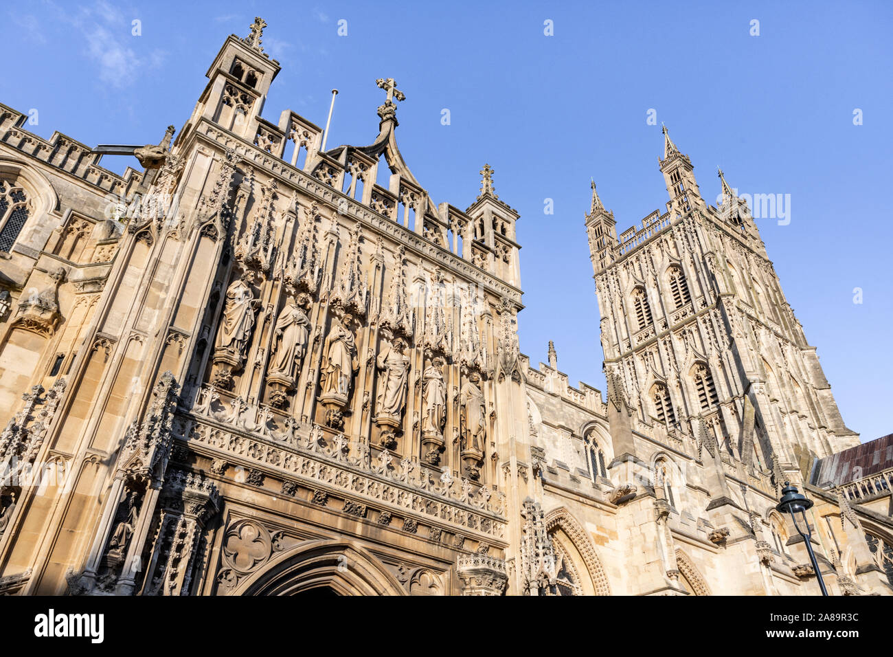 Le porche magnifiquement sculptés et décorés xve siècle tour de la cathédrale de Gloucester, Gloucester UK vue contre un ciel bleu. Banque D'Images