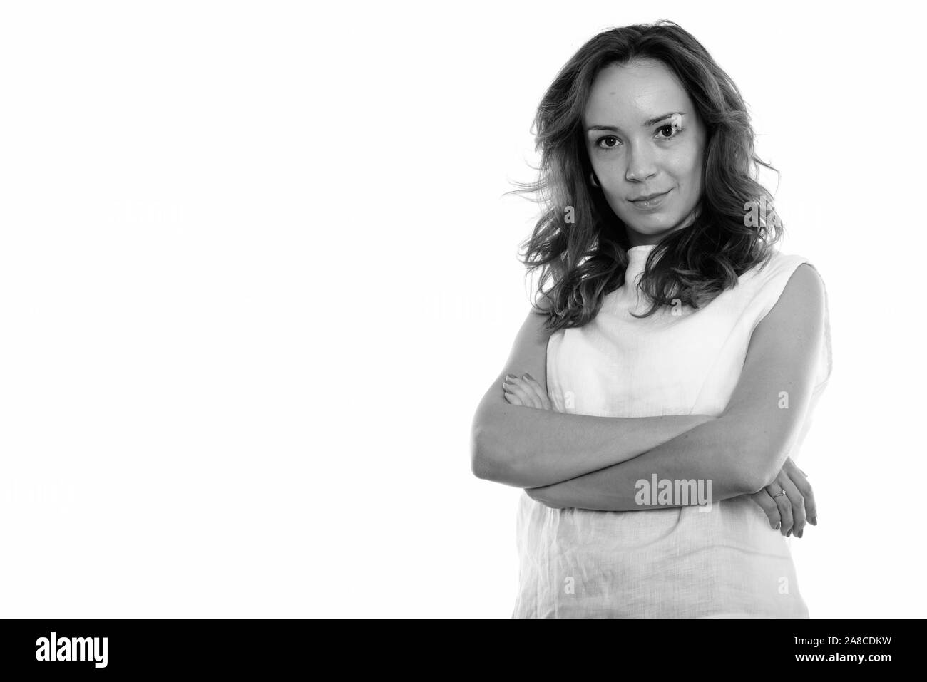 Studio shot of young Beautiful woman with arms crossed Banque D'Images