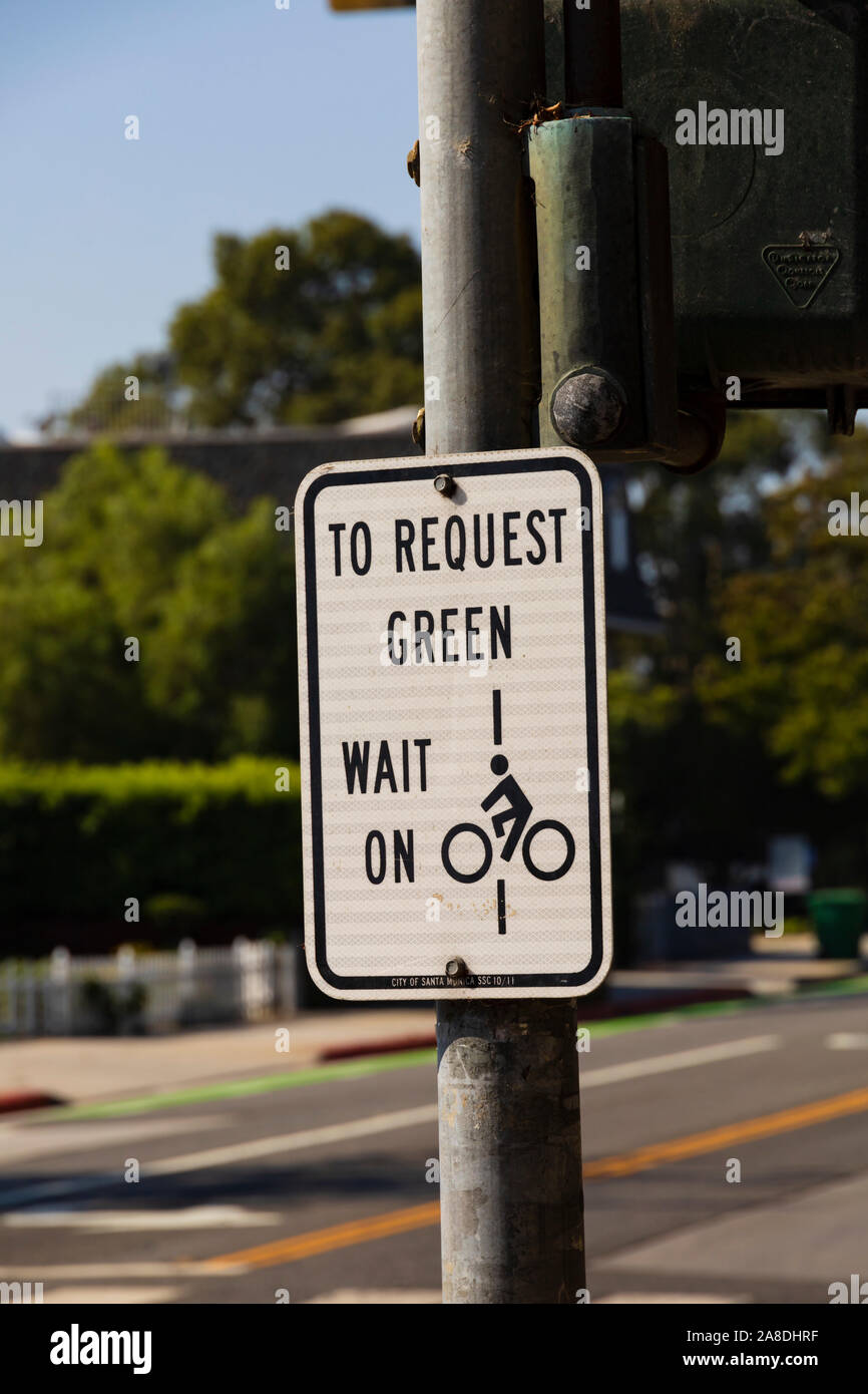 Inscrivez-vous pour les cyclistes d'attendre à traverser. Santa Monica, Los Angeles County, Californie, États-Unis d'Amérique Banque D'Images