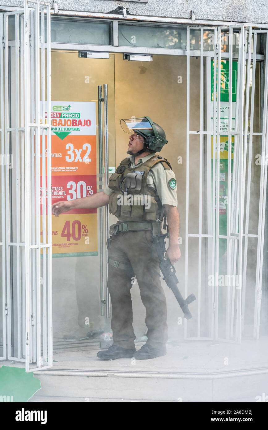 Santiago de Chile Chili le 6 novembre 2019 Agent de police ressemble à une petite entreprise au quartier de Providencia pillés pendant les dernières émeutes Banque D'Images