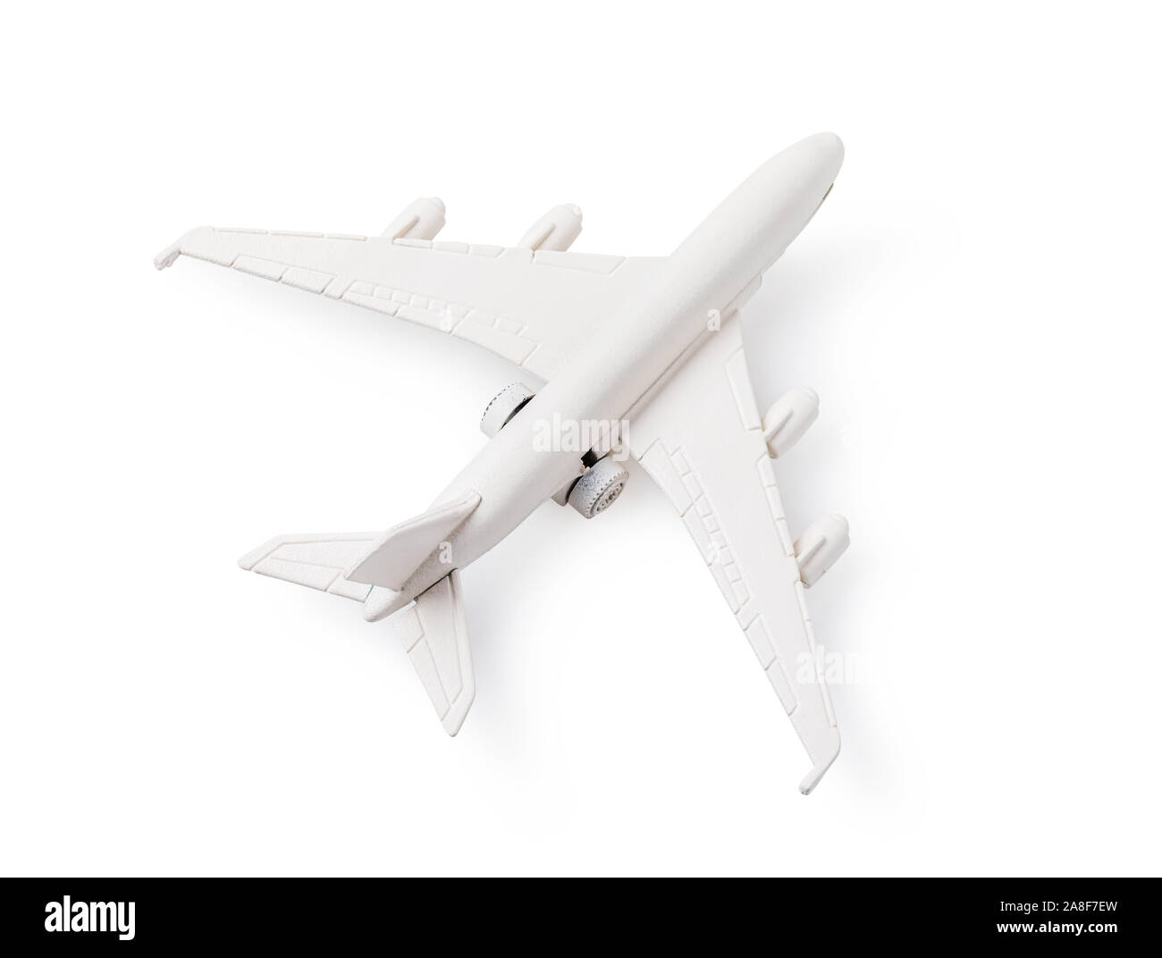 Avion jouet blanc isolé sur fond blanc Banque D'Images