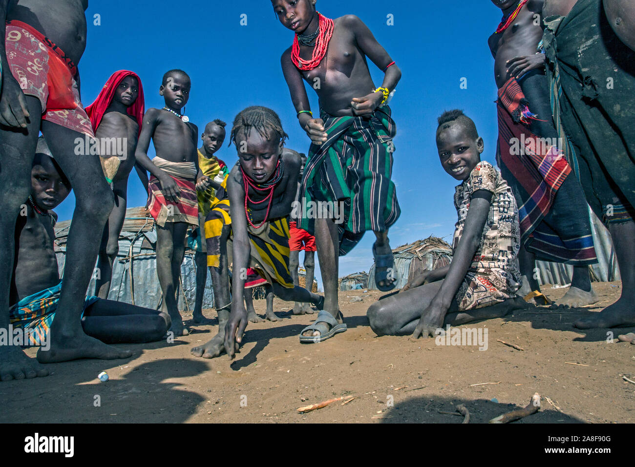 Dassenach les enfants jouer aux billes près d'Omorate Ethiopia Banque D'Images
