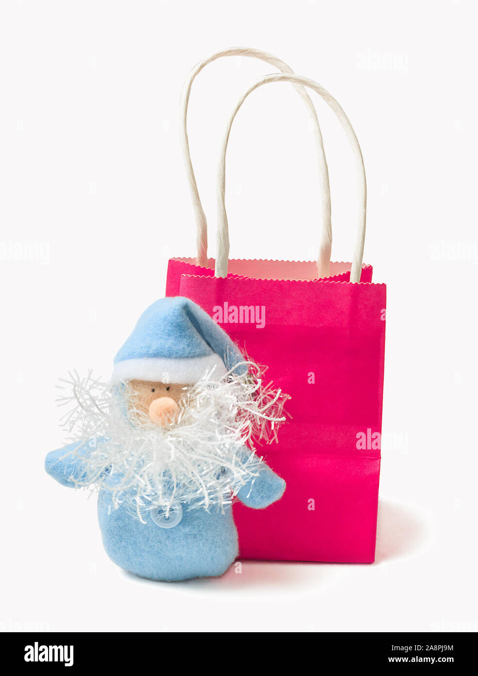 Le Père Noël bleu et rose lumineux sur sac cadeau isoler fond blanc. Carte de vœux pour le nouvel an et Noël. Banque D'Images
