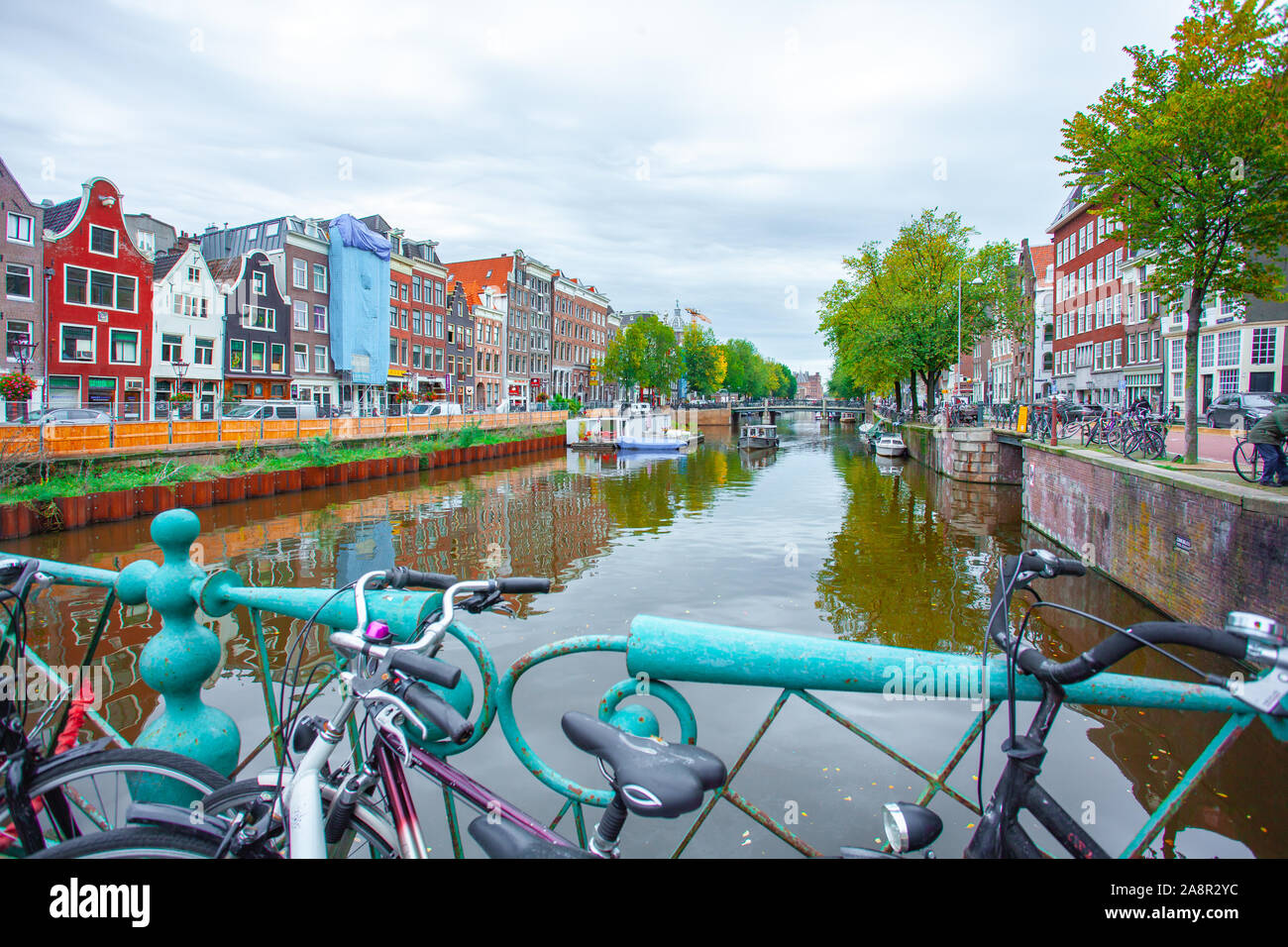 Amsterdam, Nethertlands - 14.10.2019 : Des vélos sur un pont sur les canaux d'Amsterdam. Maisons colorées et de fleurs. De l'automne. Les voyages. Banque D'Images