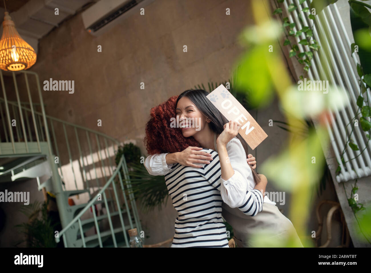 Femme radieuse se sentir heureux tout en ouvrant finalement cafétéria Banque D'Images