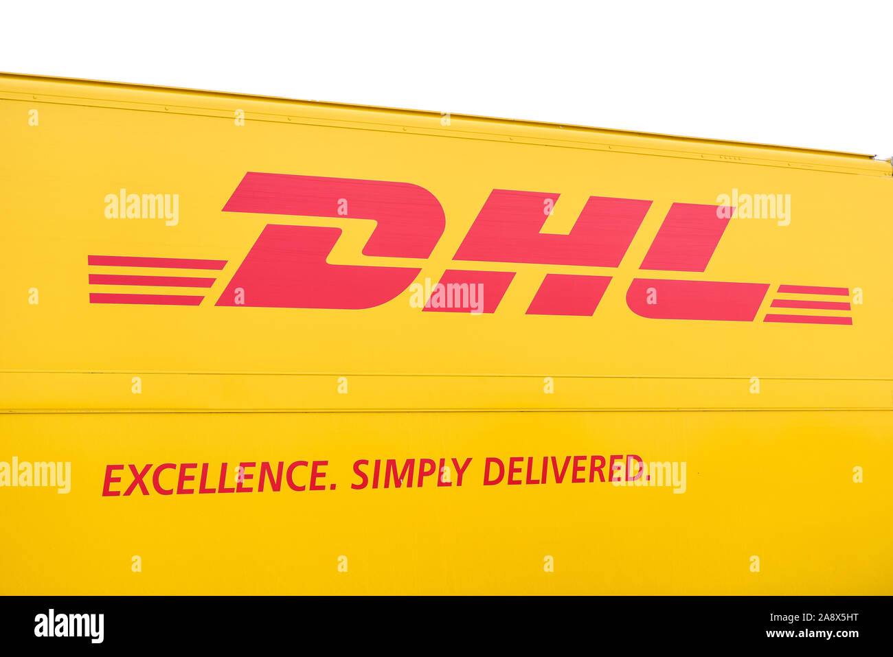 Le célèbre logo DHL sur le côté d'un camion de livraison, l'excellence. Livré simplement, courrier postal, services de transport et de livraison Banque D'Images