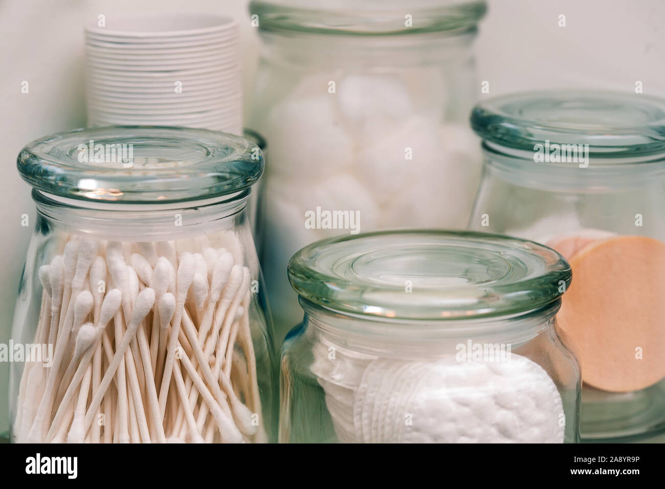 Les bocaux de verre scellé avec un démaquillant pads, coton-tiges et boules de coton pour le stockage. Banque D'Images