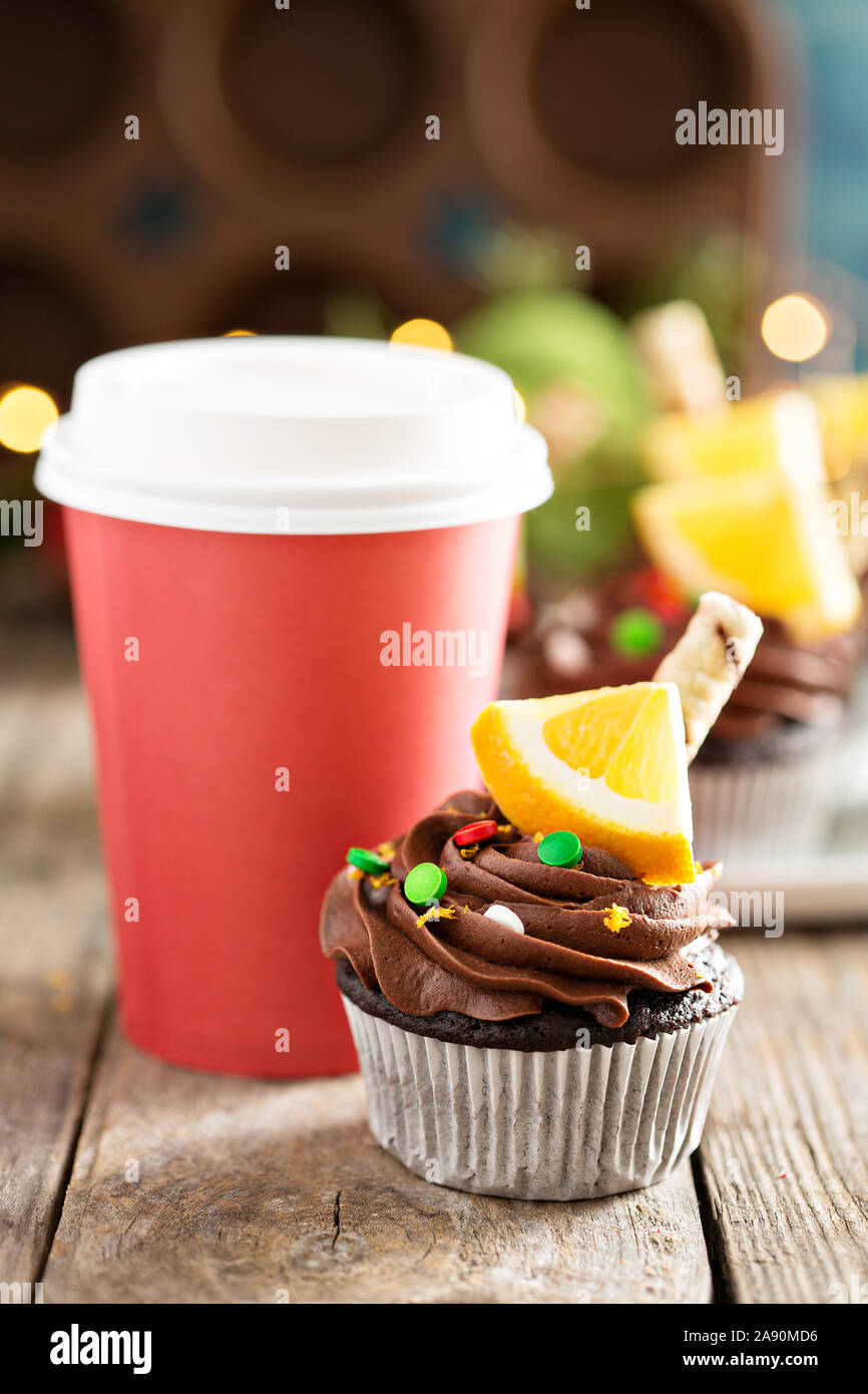 Cupcakes à l'orange et au chocolat pour Noël avec des décorations et des lumières scintillent Banque D'Images