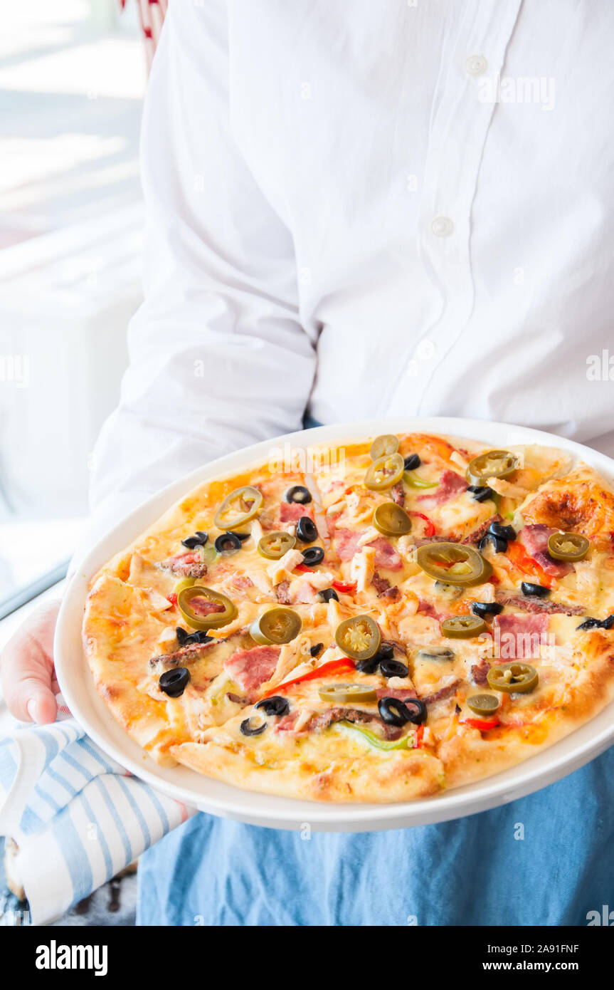 Un mexicain avec Pizza Hot Chili Peppers dans les mains Banque D'Images