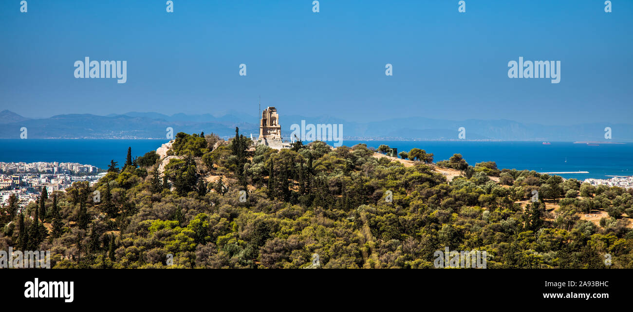 Monument au sommet de la colline de Philopappos Mouson (également connu sous le nom de colline Philopappou), avec comme toile de fond la ville d'Athènes Banque D'Images