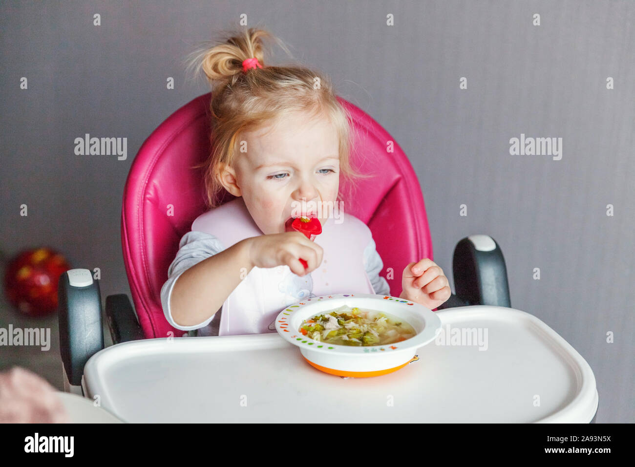 Infant Baby Avec Visage Sale Soupe Manger Elle Meme Avec Une Cuillere Cute Little Girl Sitting En Haute Chaise De Bebe Dans La Cuisine A La Maison Concept D Enfance Famille Maternite Photo Stock