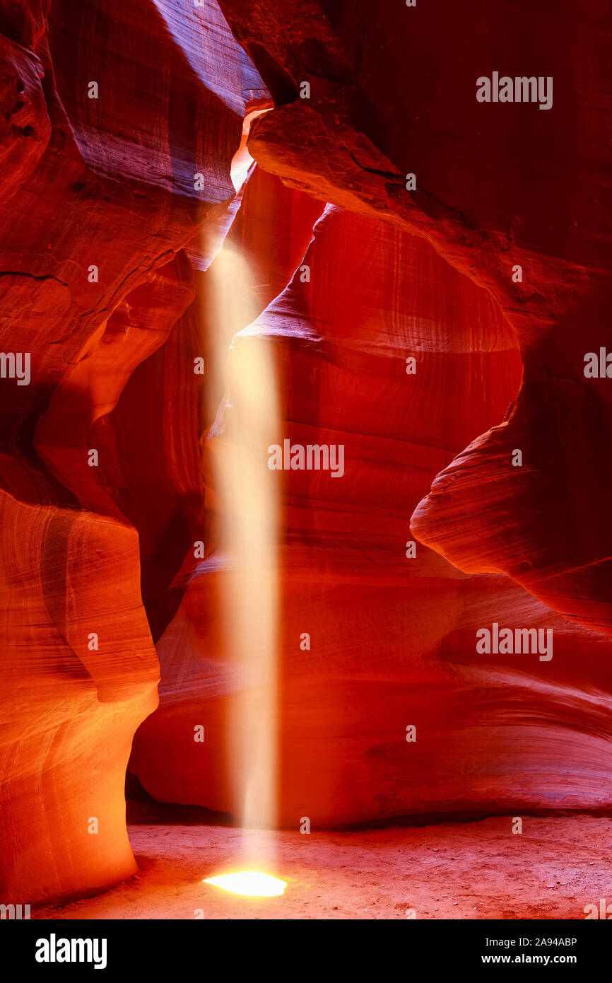 Upper Antelope Canyon avec un faisceau de lumière du soleil qui brille à travers un trou ressemblant à un projecteur au sol; Arizona, États-Unis d'Amérique Banque D'Images