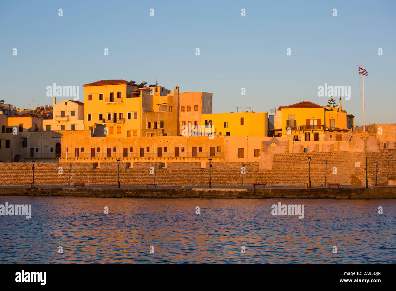 Chania, Crète, Grèce. Vue sur le port vénitien jusqu'à la forteresse de Firkas, lever du soleil. Banque D'Images