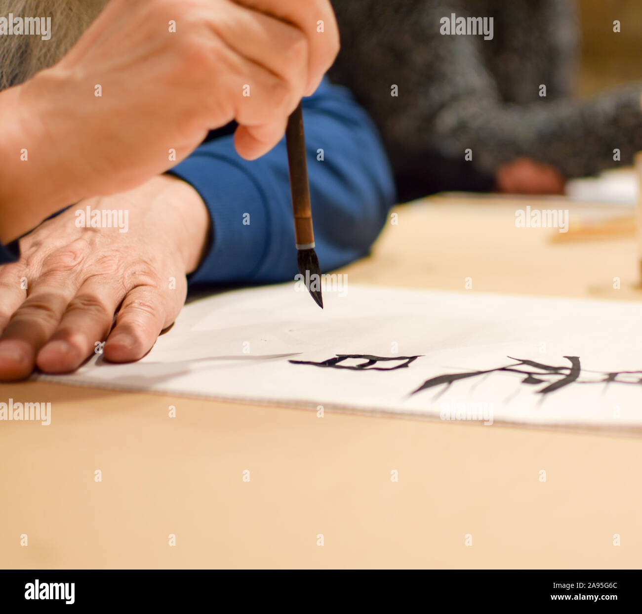 Maîtresse de dessin calligraphie hiéroglyphe chinois avec un pinceau Banque D'Images