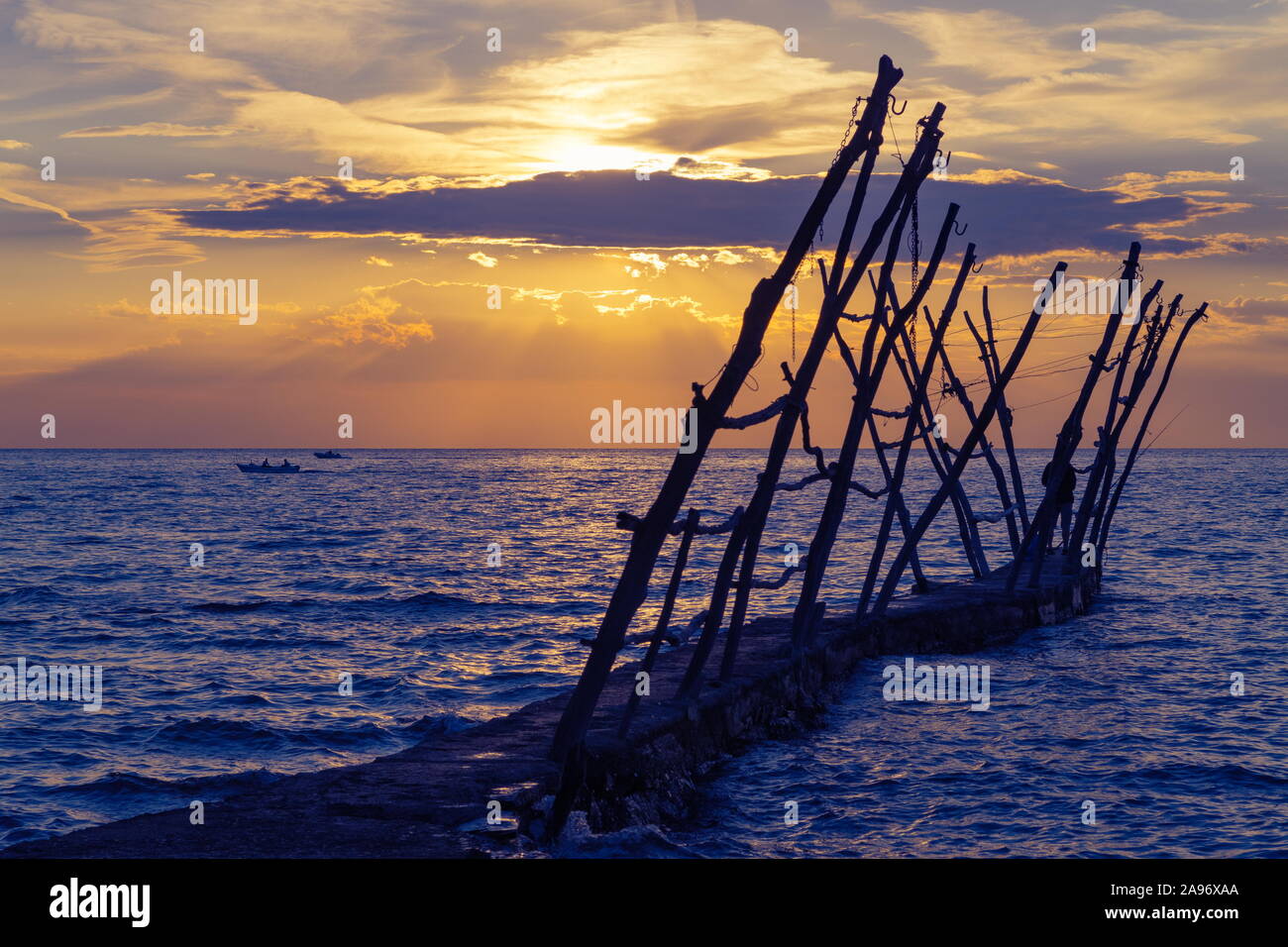 Panorama d'une ancienne jetée, pêcheur et bateaux à l'heure du coucher du soleil sur la ville côtière en Croatie Savudrija. Voyage, tourisme et vacances. Banque D'Images